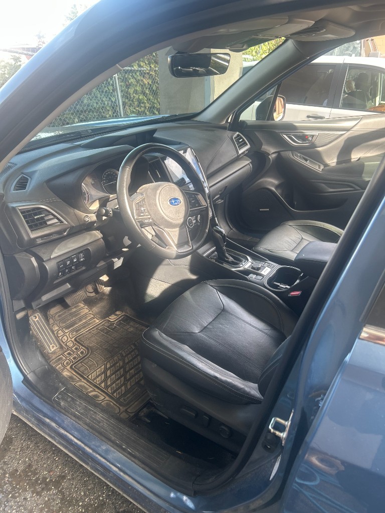 Before — dirty Subaru floor mats and cabin
