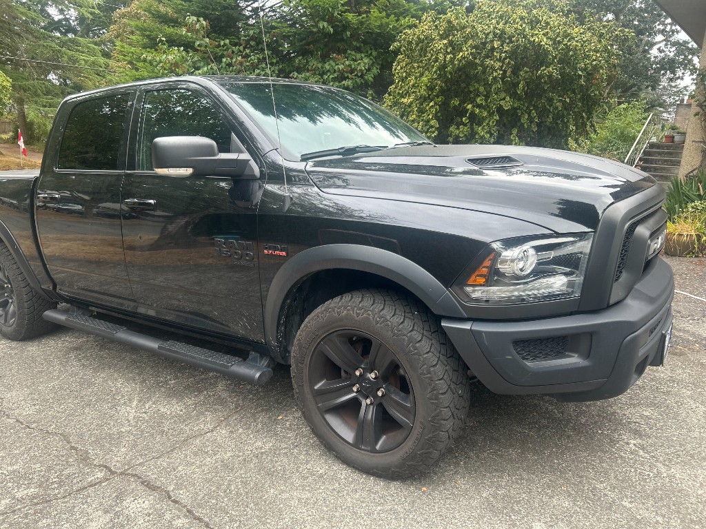 Before — dirty black RAM 1500 exterior