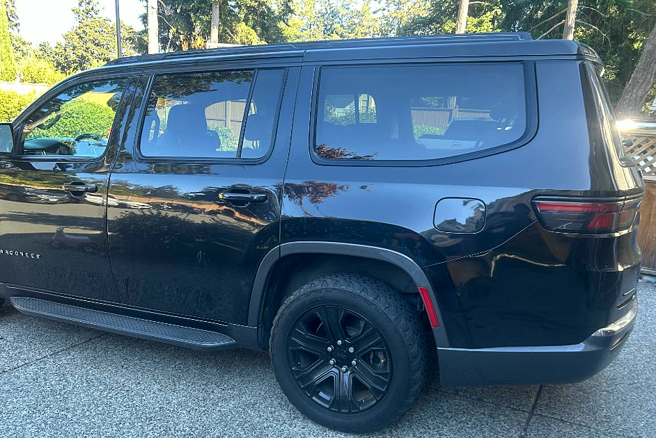 Glossy black Jeep Wagoneer after a mobile exterior detail