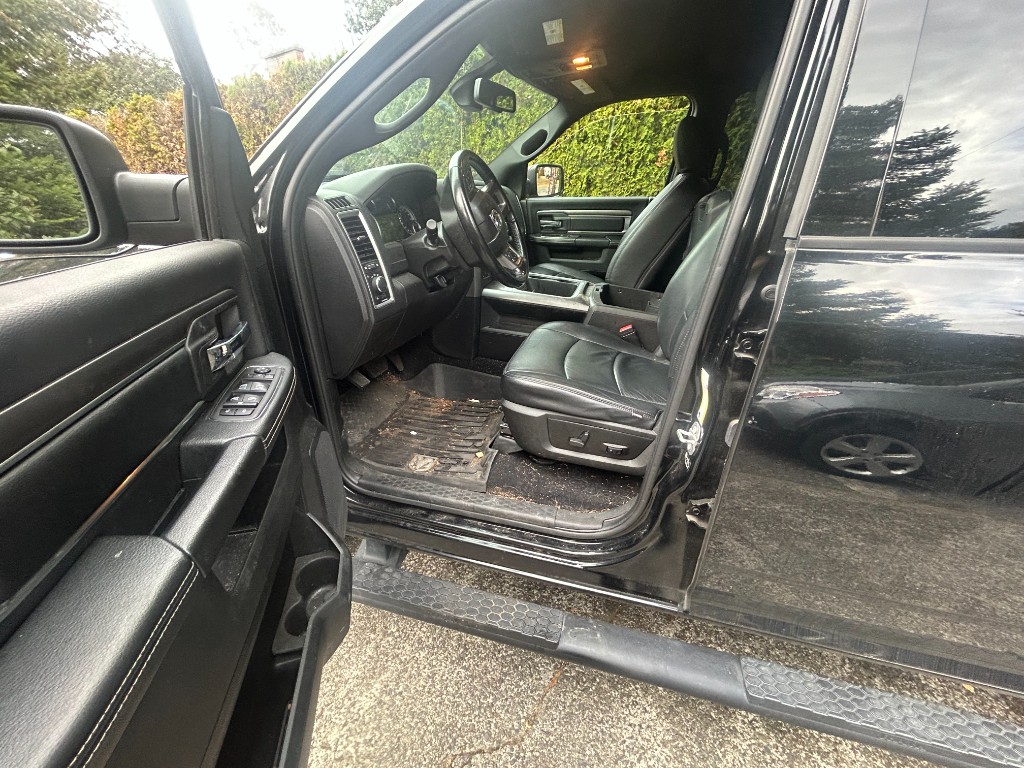 Before — muddy pickup truck front interior with debris on floor mats and seats